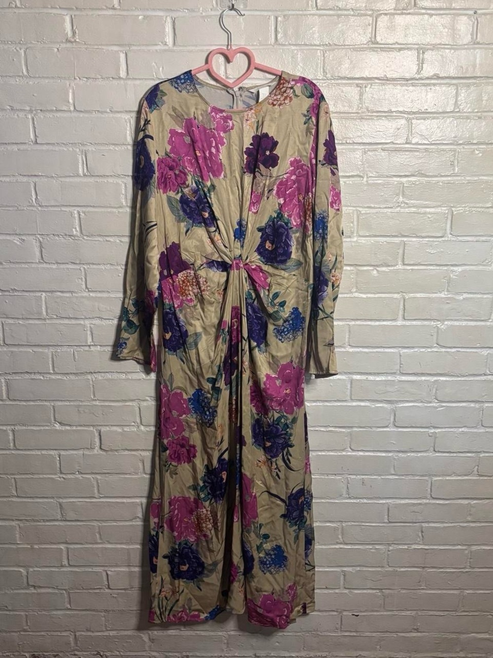 H&M floral maxi dress with pink, purple, and blue flowers on a beige background.